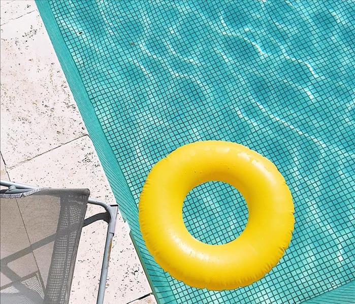 yellow floating device in pool