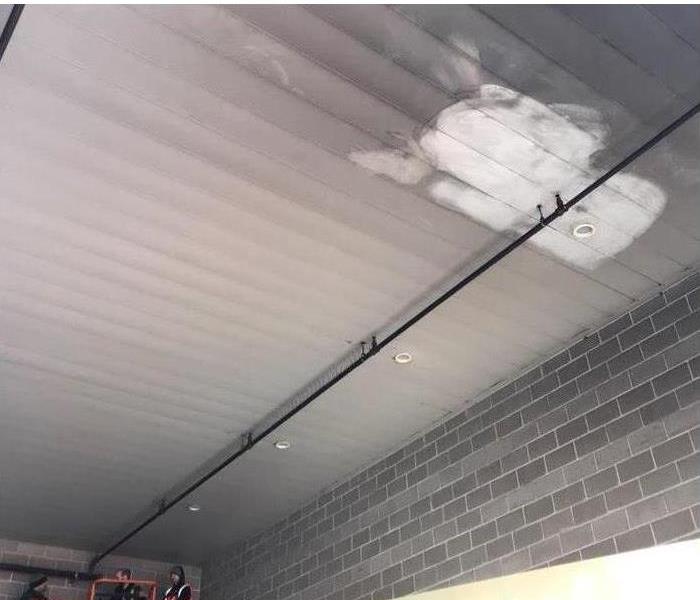The ceiling of a commercial premises dirty with soot