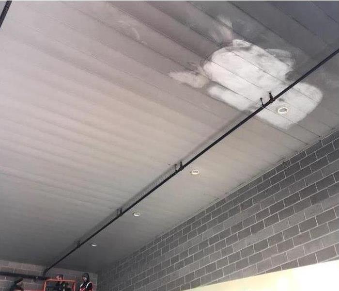 ceiling of a commercial building covered with smoke